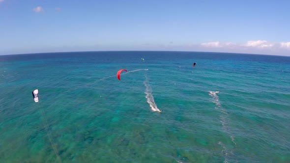 Aerial view of a man kitesurfing in Hawaii.