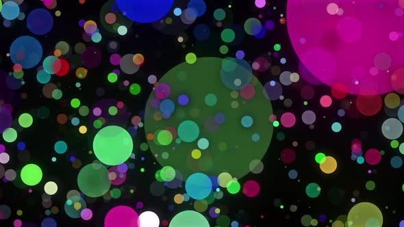Multicolored confetti or glitter particles glitter in the light with depth of field.