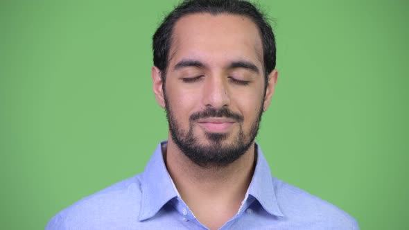 Young Happy Bearded Indian Businessman Relaxing with Eyes Closed