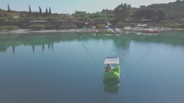 Aerial view of a colorful pedal boat in the lake. Holiday and relaxation concept