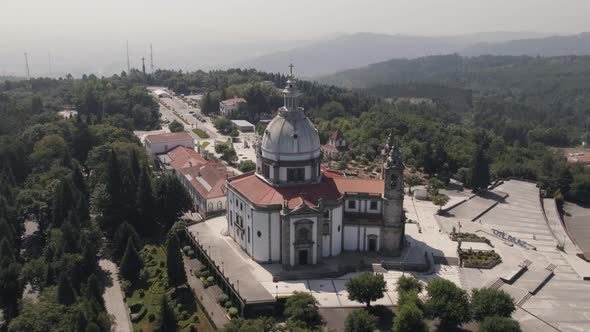 Aerial drone circling ascendent around Sanctuary of Our Lady of Sameiro on hilltop, Braga. Portugal