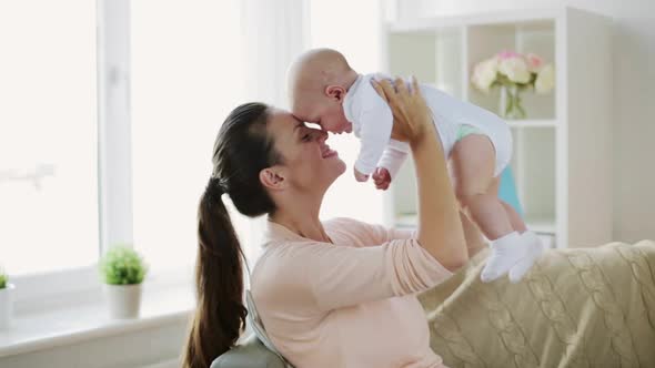 Happy Young Mother with Little Baby Son at Home