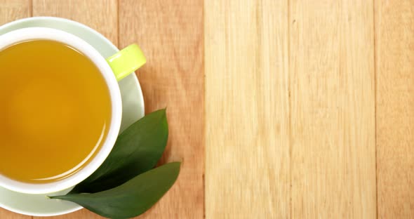 Close-up of tea cup with saucer and tea leaves