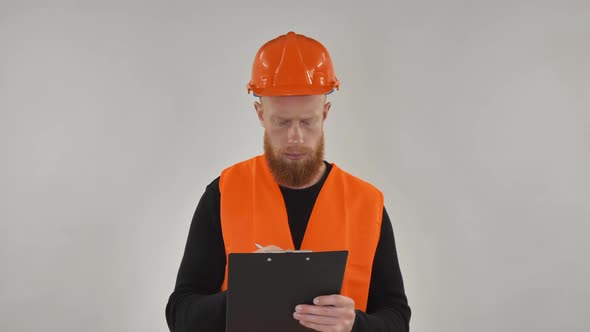 Red-haired Guy Wearing a Construction Helmet Portrait