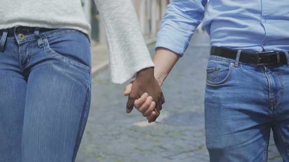 Closeup Shot of Multiracial Couple Holding Hands Together