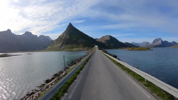 Driving a Car on a Road in Norway Lofoten