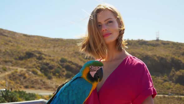 Blonde Model Looking at Parrot then Sideways