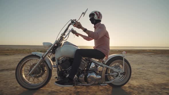 Motorcyclist Driving His Motorbike on the Dirt Road During Sunset Slow Motion