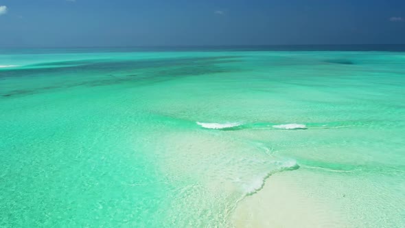 Aerial flying over texture of marine island beach break by transparent ocean with white sand backgro