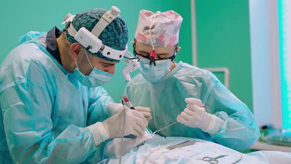 Surgery team in operating room. Group of surgeons at work in operating theater