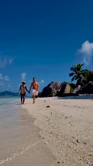 Anse Source d'Argent La Digue Seychelles Young Couple Men and Woman on a Tropical Beach During a