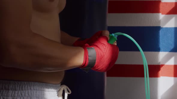 Side view of caucasian man working out in boxing gym