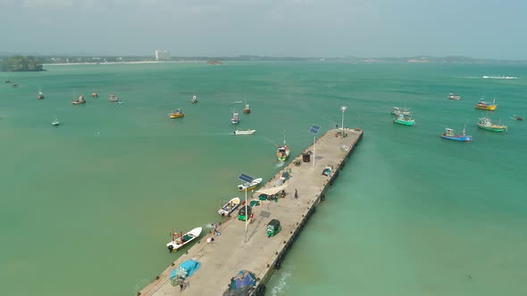 Colorful Fishing Boats Off A Cement Pier Solar Panels