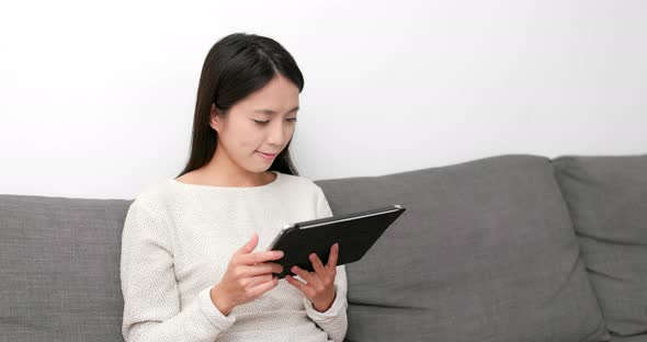 Woman use of digital tablet computer at home