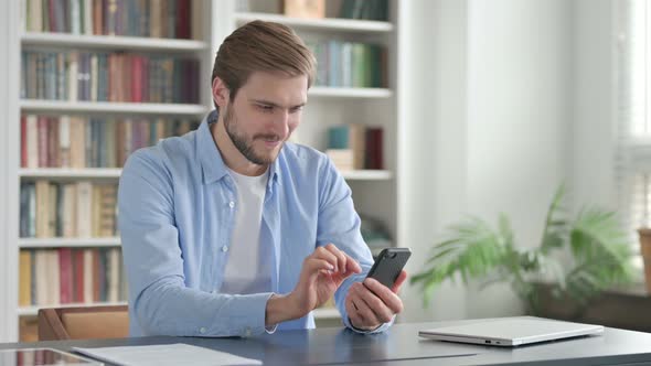 Successful Man Celebrating on Smartphone