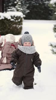 Children i Building a Snowman on a Winter Day at Backyard