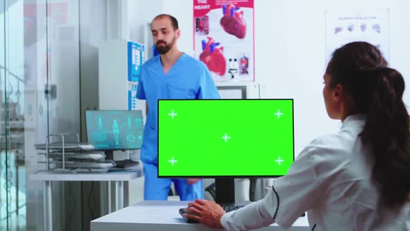 Doctor Using Computer with Green Mockup