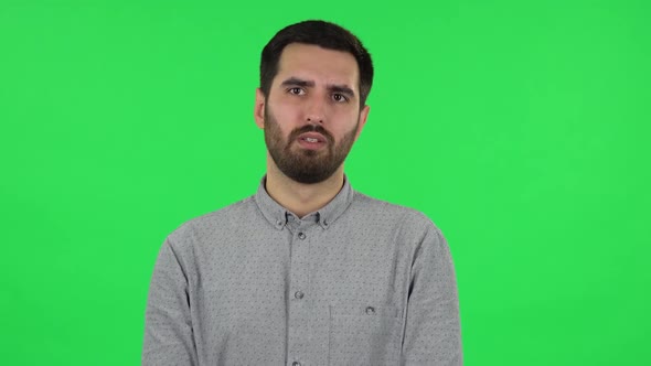 Portrait of Brunette Guy Is Reporting and Telling a Lot Information. Green Screen