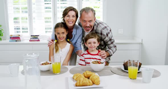 Happy family at breakfast table