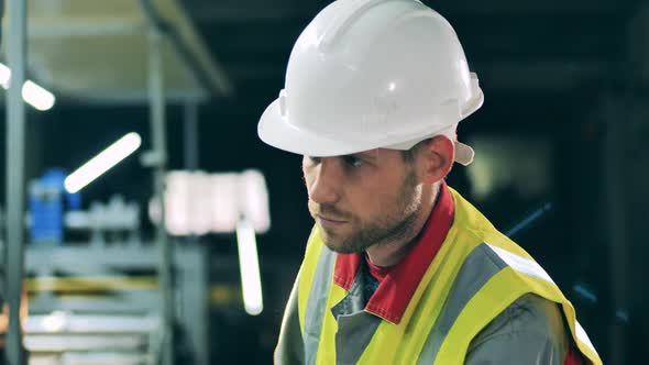 Factory Unit with a Male Engineer in a Hardhat and a Safety Vest