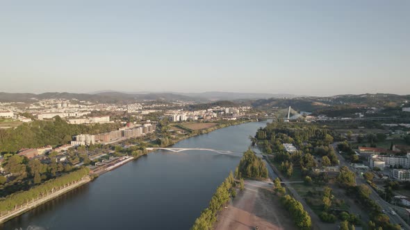 Aerial view over Mondego River in Coimbra City, Green park on Riverside