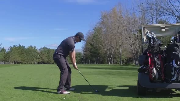 golfer swing and hits the ball slider view