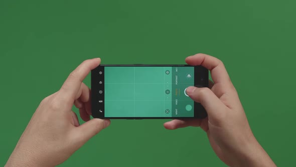 Hands Holding Cell Phone And Talking Photos With Green Screen In Green Background