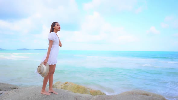 Asian woman enjoy around beautiful beach sea ocean