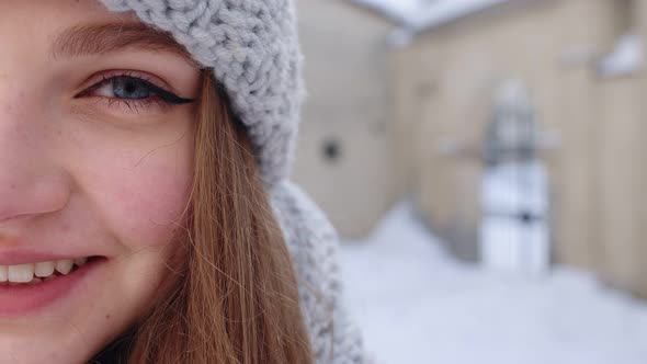 Closeup of Cheerful Positive Young Woman Face Smiling To Camera While Standing Outdoors in Winter