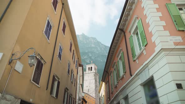 Narrow Street with Historical Buildings Under Cloudy Sky