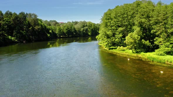 Wide river among the forest, aerial view of Poland