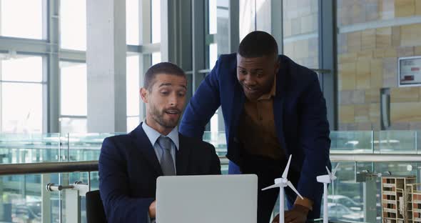 Young businessmen using laptop in a modern office