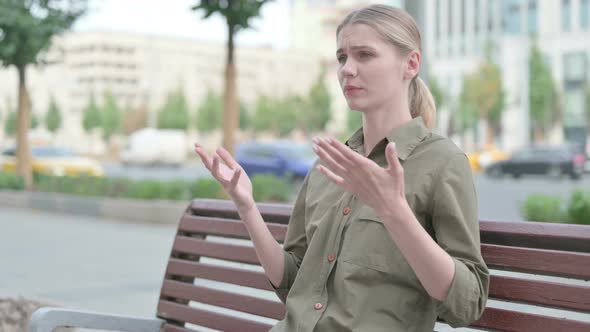 Angry Displeased Woman Feeling Frustrated while Sitting Outdoor on Bench