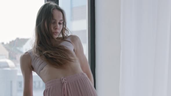 A Young Woman Dances and Uses Blue Sweater in Her Dance