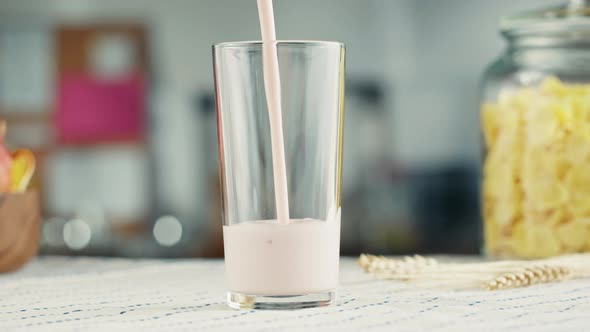 Pouring Yogurt Into Glass Cup Closeup