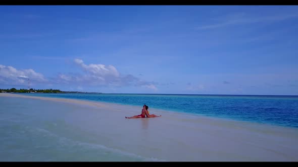 Boy and girl sunbathe on exotic bay beach journey by turquoise sea and white sandy background of the