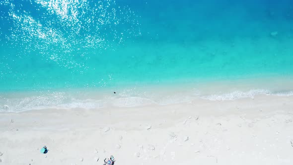 Drone view of scenic beach with white sand and turquoise sea, Greek islands.