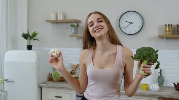 Girl Recommending Eating Raw Vegetable Food. Showing Broccoli and Cauliflower. Weight Loss, Diet