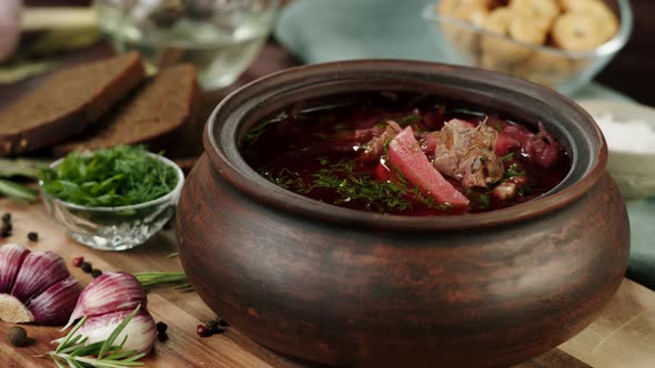 Sprinkling Greenery Dill and Parsley Into Boiled Borsch Closeup Cooking Soup Made of Beetroot