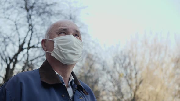 Elderly Man with a Handmade Mask