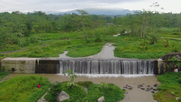 Aerial dolly view revealing Grojogan Watu Purbo Waterfall, Java, Indonesia