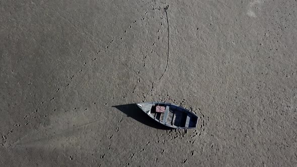 Top View of Boat at Shore of Dried Up Sea Global Warming and Drought Concept