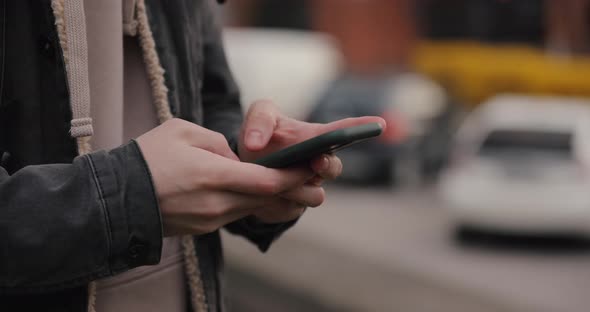 Closeup of Smart Phone in the Male Hands at the City