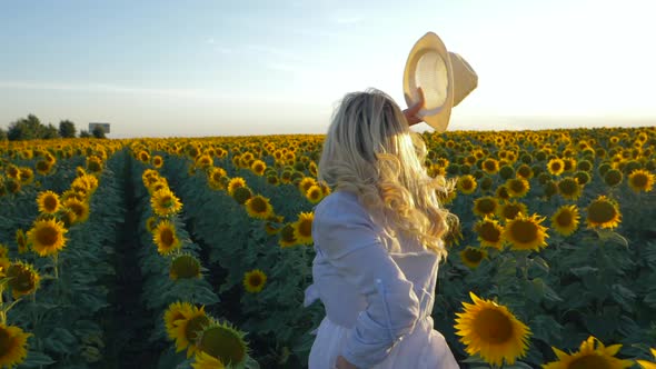 Young Beautiful Blonde Woman Running Sunflower Field