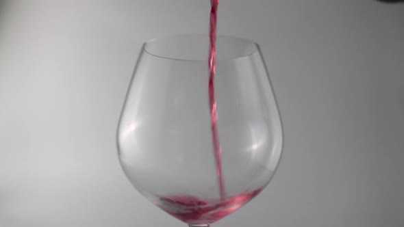 Close Up Of Pour Red Wine In To A Glass