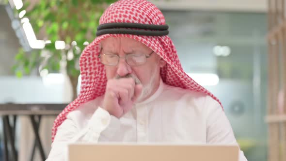 Old Arab Businessman with Laptop Coughing