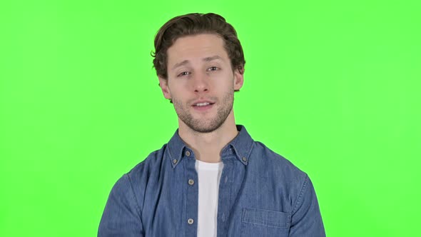 Young Man Pointing at Camera and Inviting on Green Chroma Key