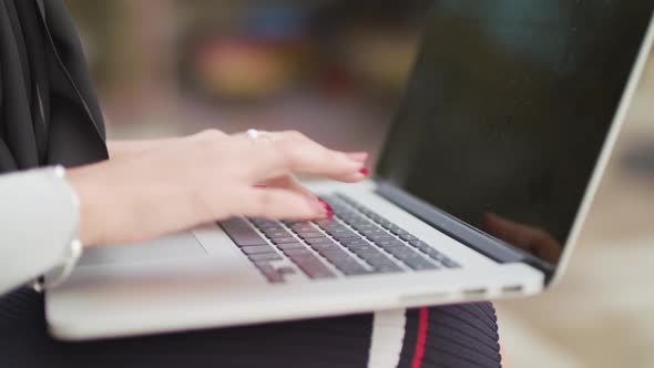 Close Up Shot Of Woman Typing On Keyboard Whilst Working Outside , In Slowmotion.