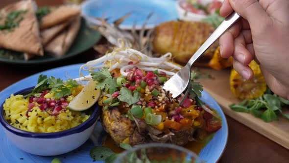 Fork Picking Thai Curry Served in a Pineapple