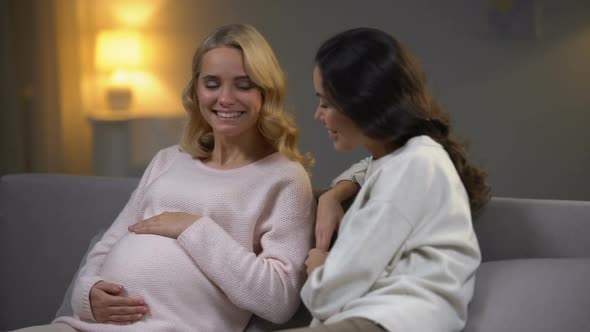 Young Woman Visiting Her Pregnant Friend at Home, Happy Motherhood, New Life